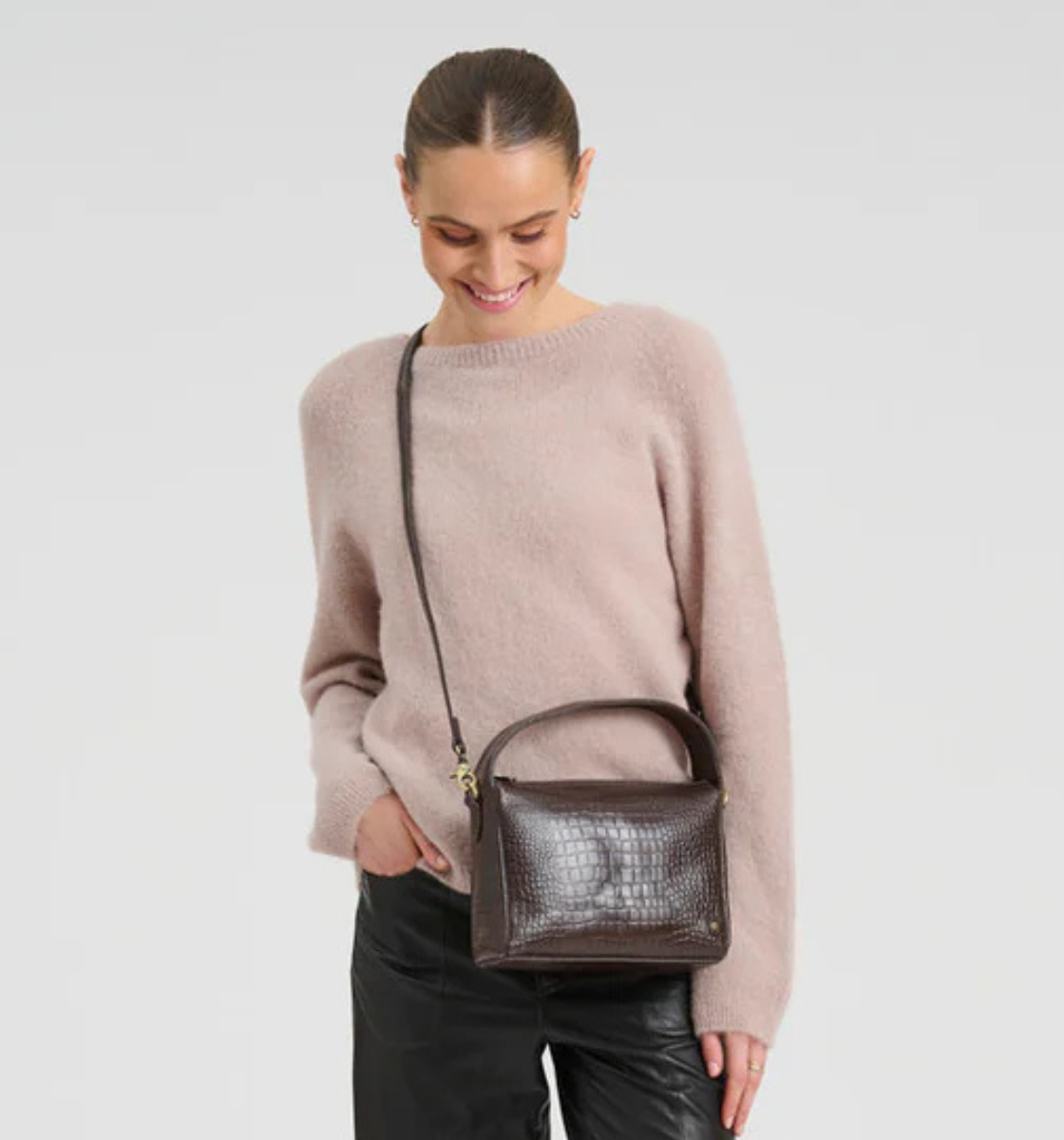 Woman wearing croc brown leather crossbody bag in Ireland