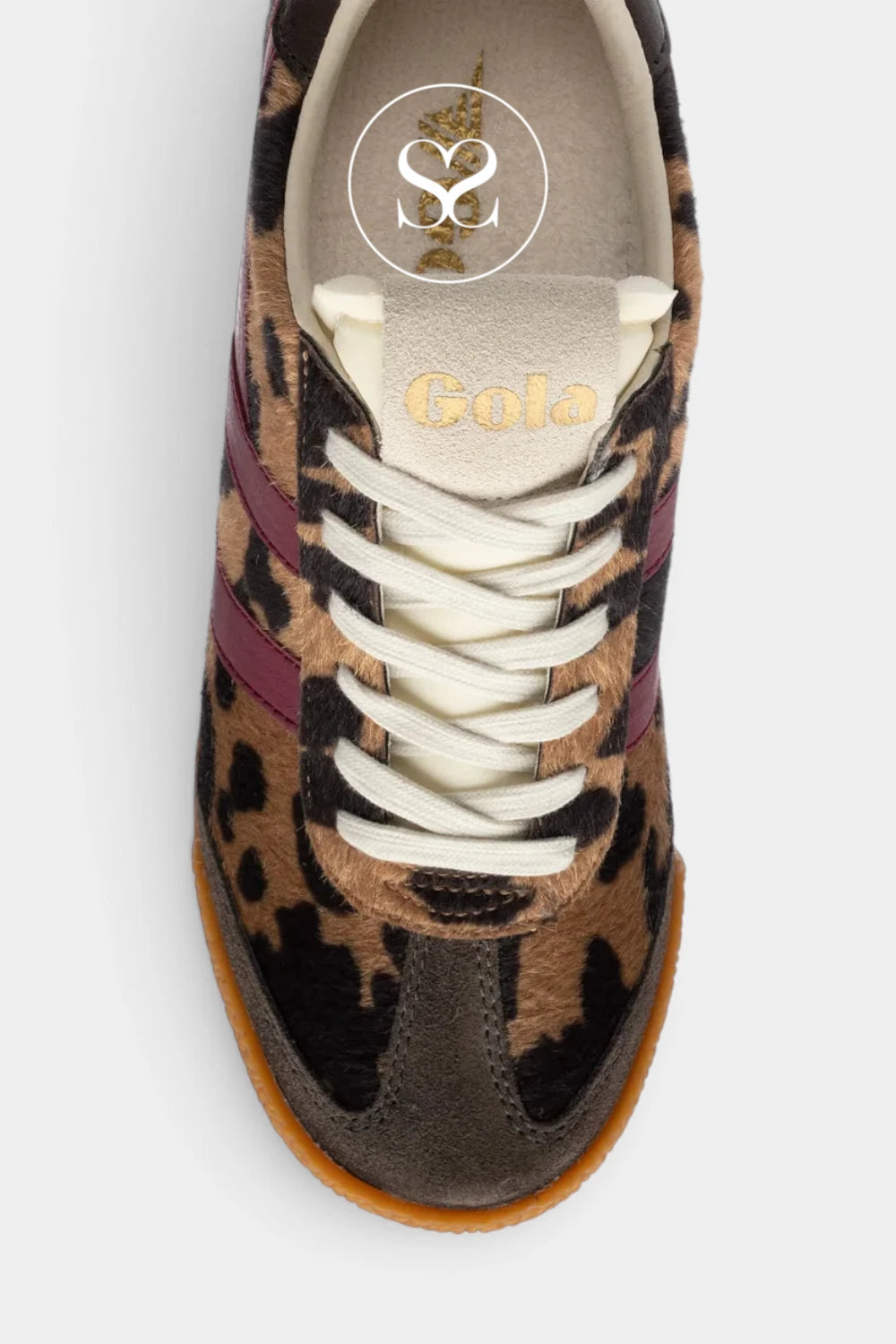 A top-down view of a Gola brand sneaker featuring a brown and black leopard print pattern, white laces, burgundy side stripes, and a brown rubber sole, set against a light gray background.