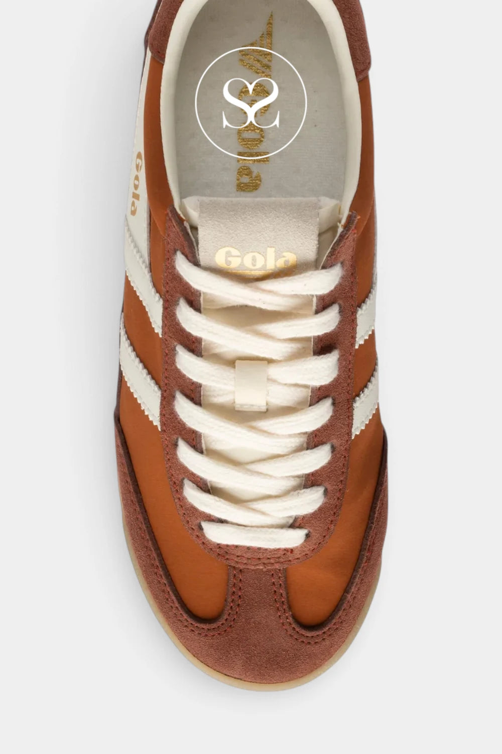 A top-down view of a brown suede and leather sneaker with white side stripes, white laces, and a cream-colored interior. The brand name 'Gola' is visible on the tongue and insole.