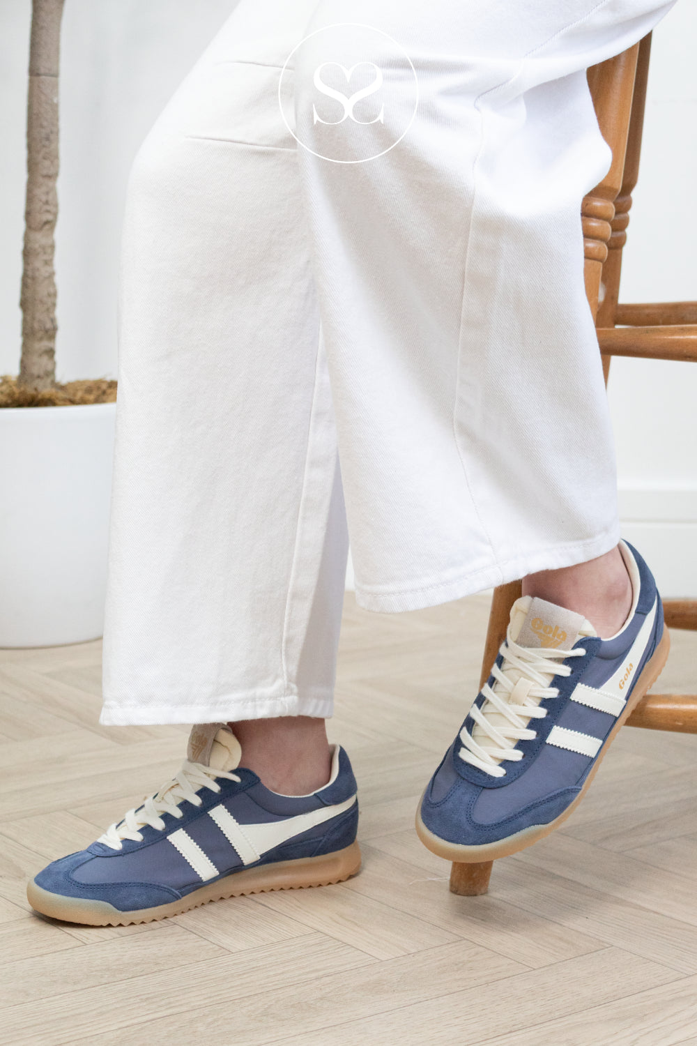 Woman wearing blue suede retro trainers from Gola