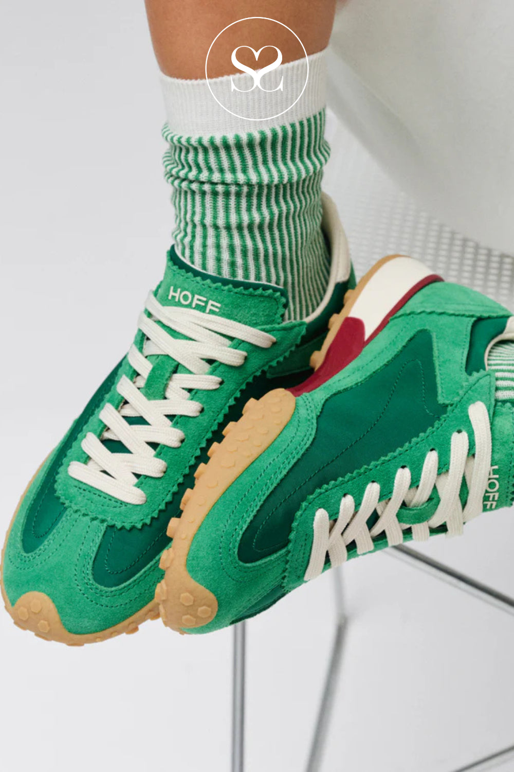 Green HOFF trainers for women styled with white laces worn with green and white striped socks 