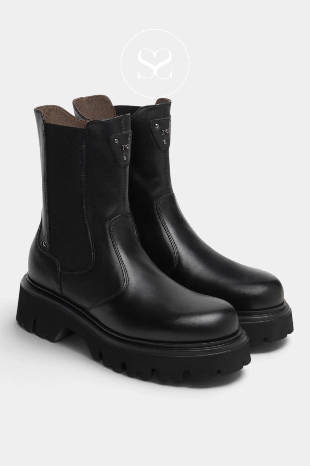 A pair of black leather Chelsea-style boots with chunky lug soles, shown from a three-quarters angle on a light gray background.