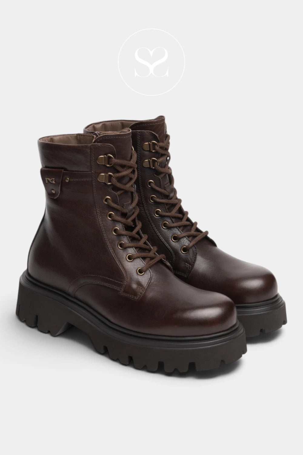 A pair of dark brown leather lace-up boots with chunky lug soles and gold-tone hardware, displayed on a light gray background.