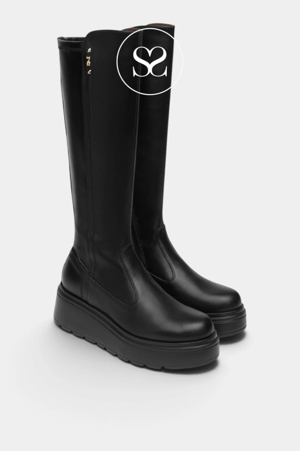 A pair of black leather knee-high boots with chunky platform soles, shown from a three-quarters angle on a light gray background. A circular logo overlay with 'S2' is visible on the upper boot.