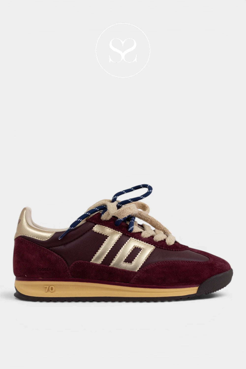 A low-top sneaker in burgundy suede and leather with gold colored '70' side stripes, cream laces, a gold heel tab, and a gold midsole.