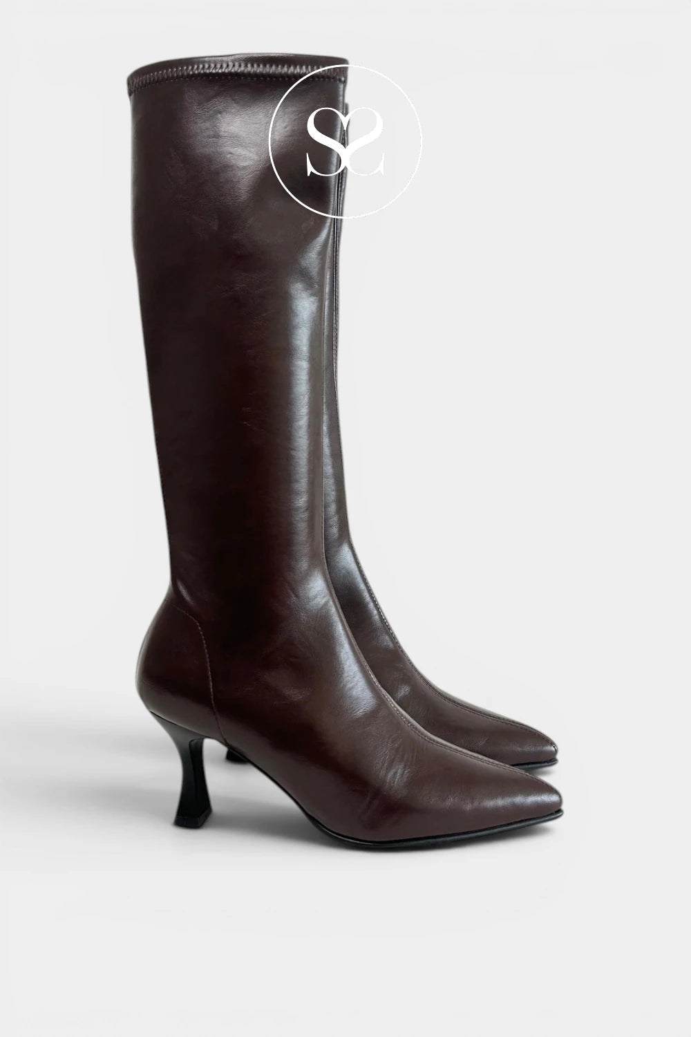 A pair of Miss Elastic chocolate brown leather knee-high boots with pointed toes and kitten heels, shown against a light grey background.