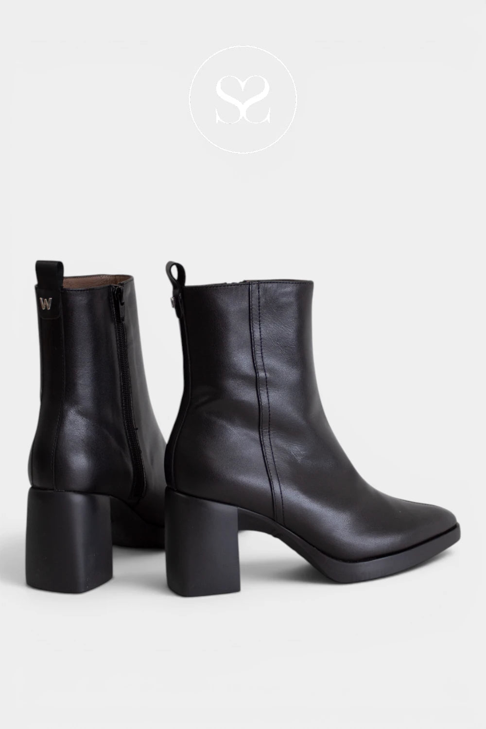 Black block heel boots featuring a sturdy mid-height heel for comfortable everyday height.