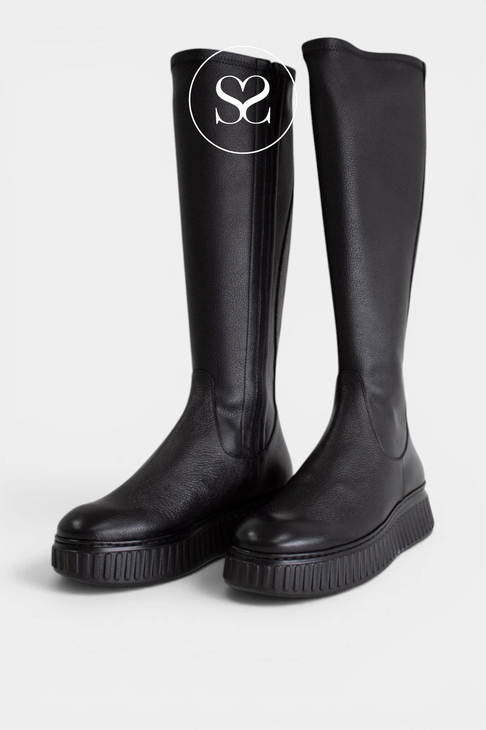 Chunky black long boots for women combining textured leather, a bold platform sole and simple tonal detailing for a versatile casual look.