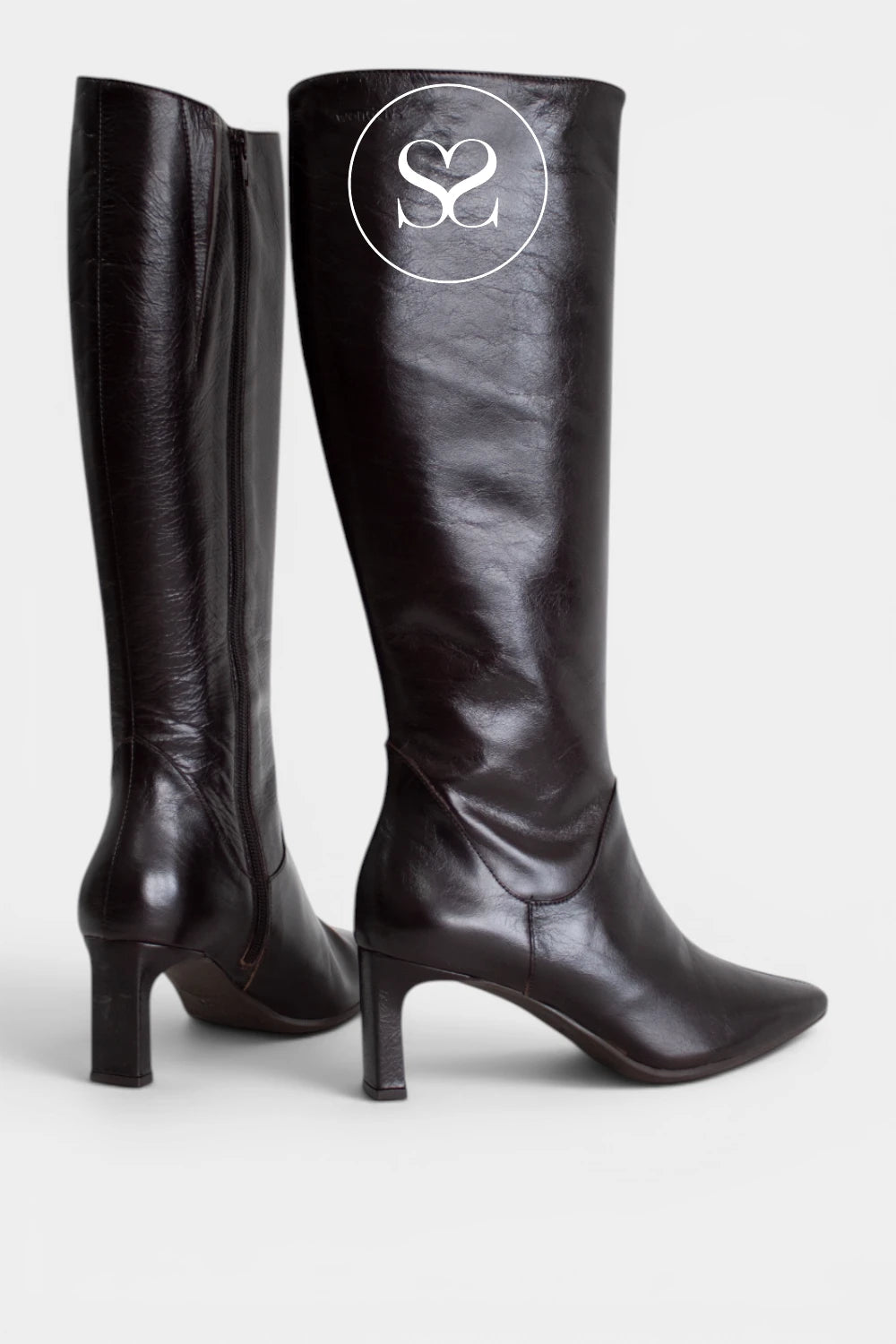 Dark brown long boots with a pointed toe, ideal for wearing with dresses, skirts or fitted trousers.
