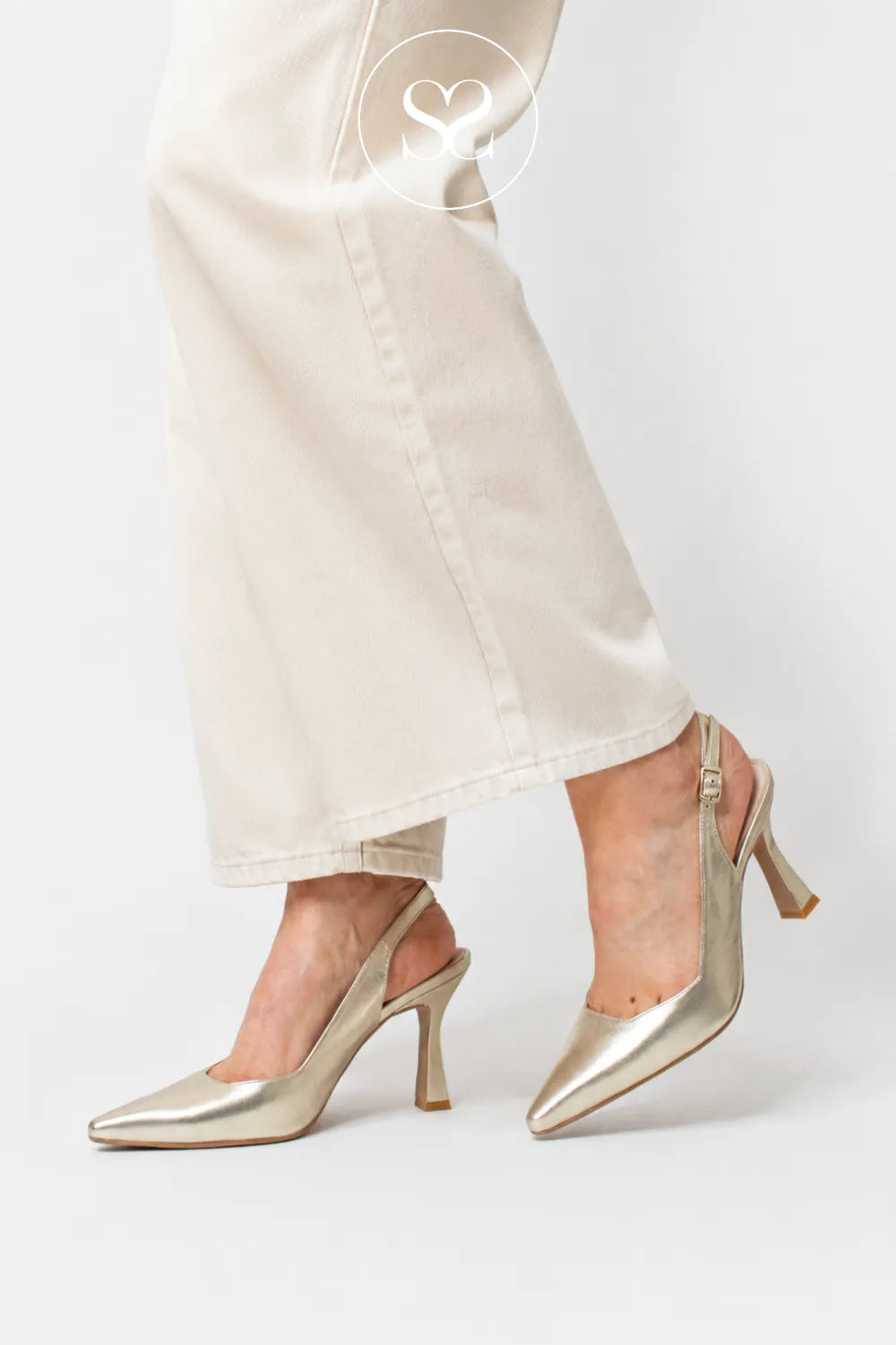 LODI MODERN GOLD LEATHER POINTED TOE HIGH HEEL WITH SCULPTED HEEL AND ADJUSTABLE SLINGBACK STRAP - WORN WITH CREAM BARREL LEG JEANS IN IRELAND