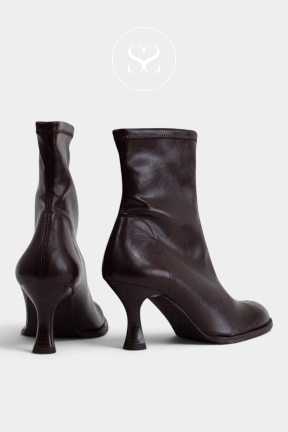 A pair of dark brown leather ankle boots with kitten heels, shown from both the side and back angles against a light grey background - Miss Elastic boots at Sheneil Shoes In Ireland