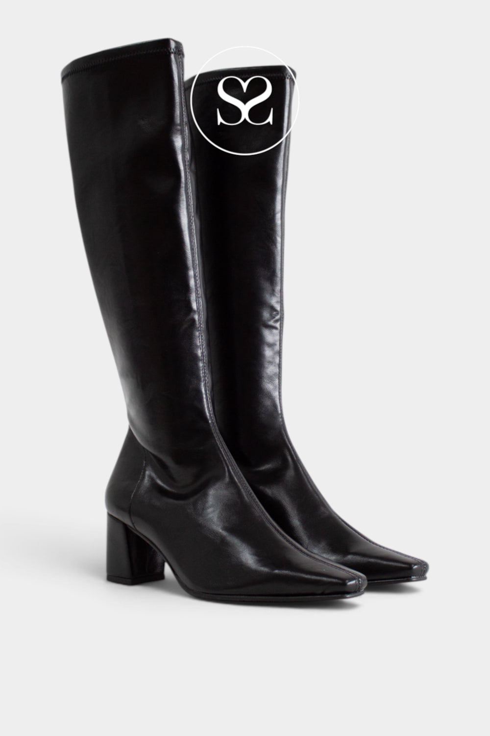 A pair of black knee-high leather boots with a pointed toe and block heel, shown against a light gray background. A circular logo overlay featuring the initials 'SS' is positioned near the top of the right boot.