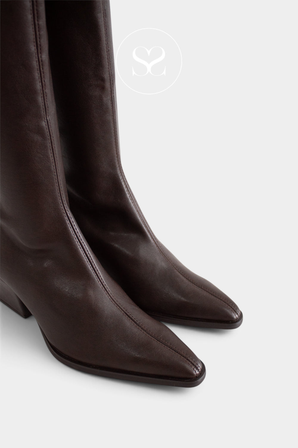 Miss Elastic Dark brown leather pointed-toe heeled boots shown in a close-up studio shot against a light grey background.