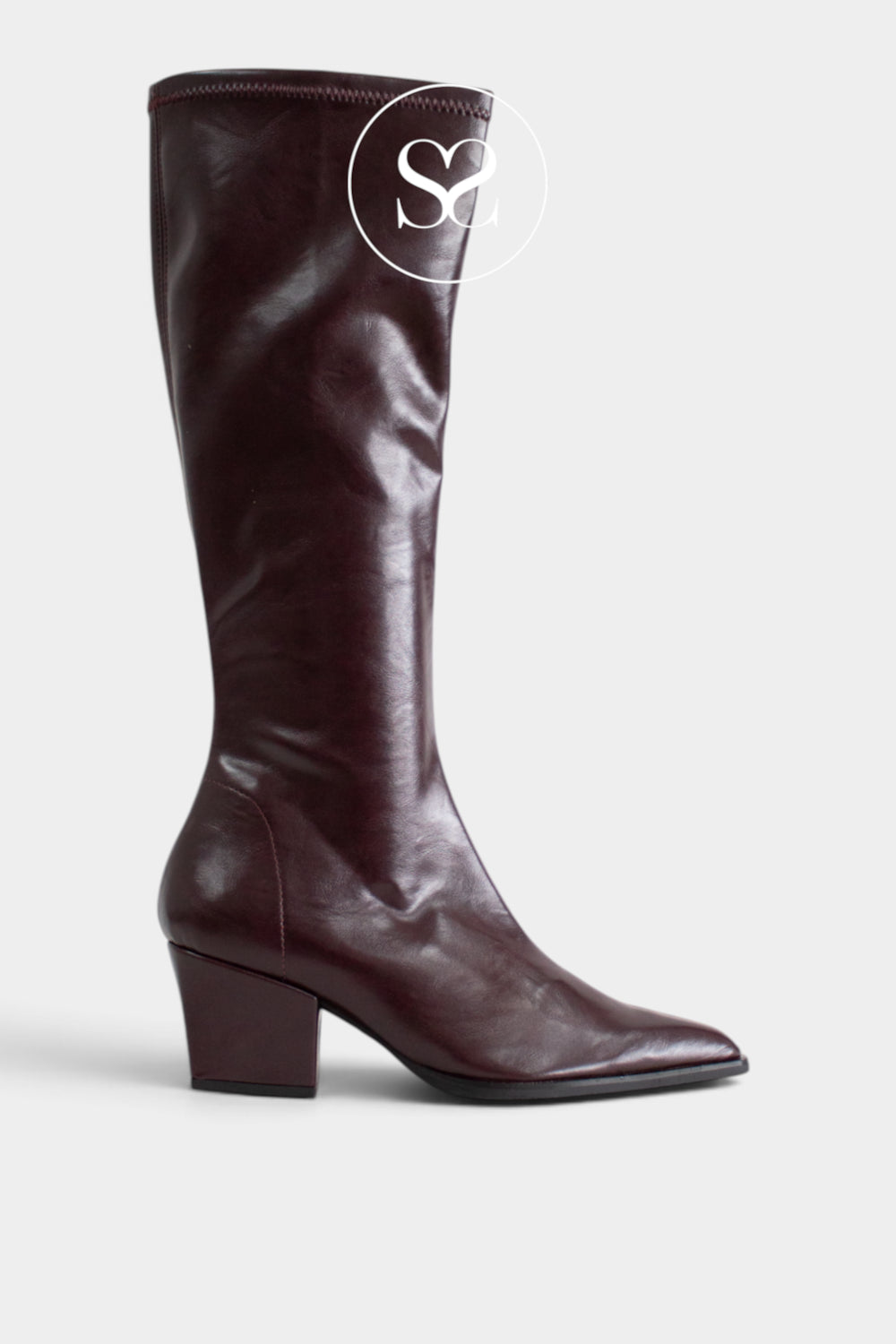 A dark burgundy leather knee-high boot with a low block heel and pointed toe, shown from a side profile on a light gray background. A circular 'Sheneil Shoes' logo watermark is visible near the top.
