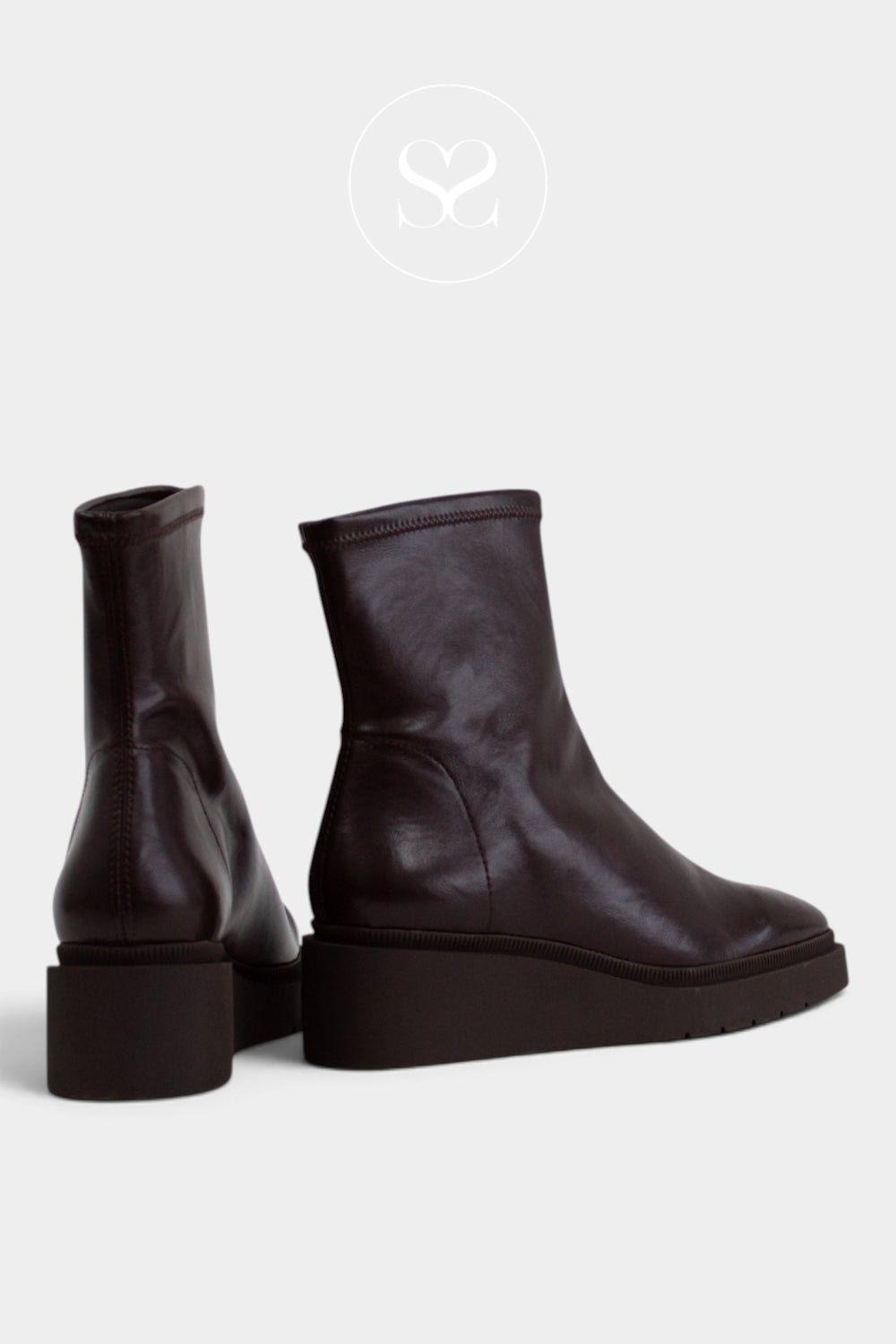 A pair of dark brown leather ankle boots with chunky platform soles, shown from the side and back on a light grey background from Miss Elastic