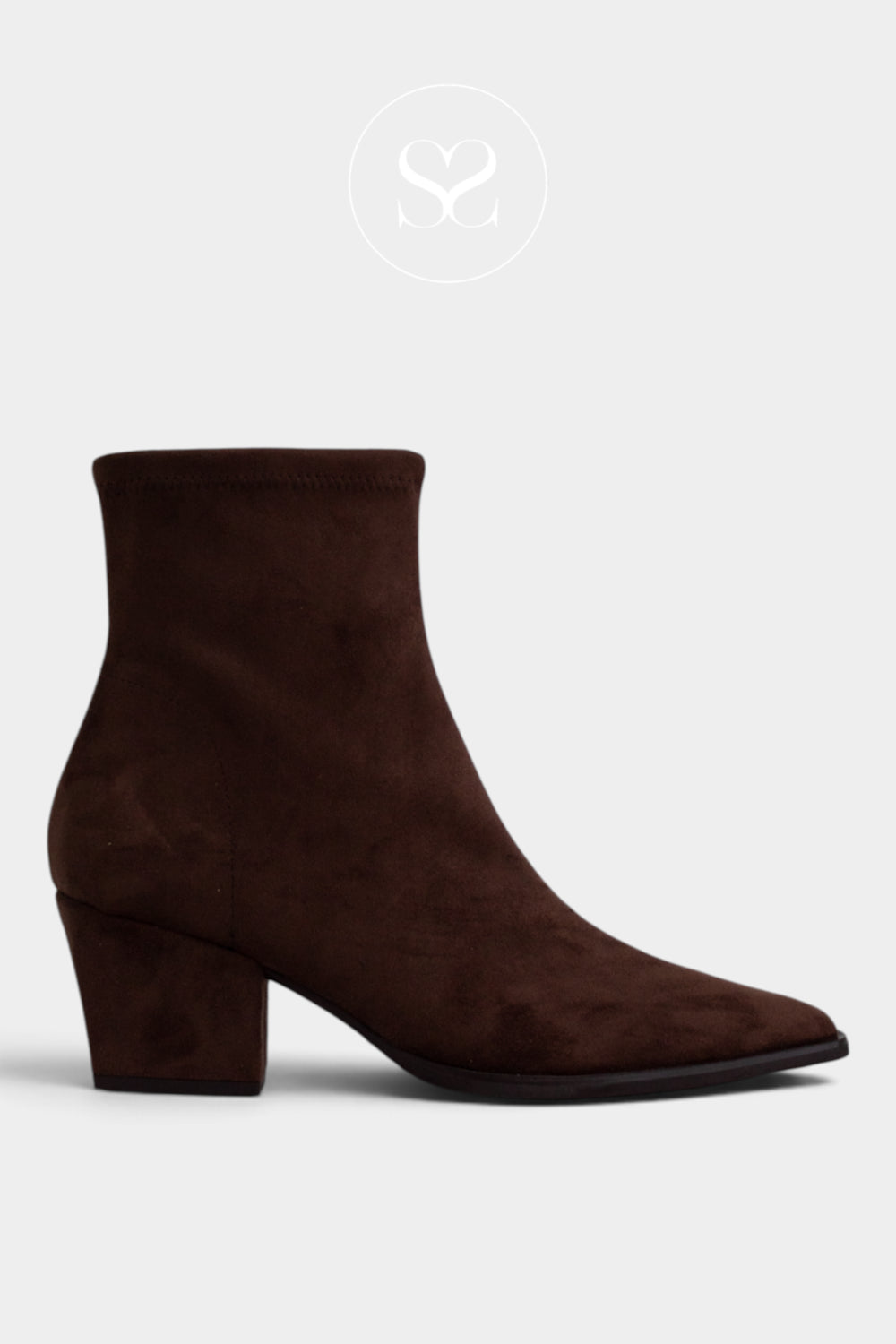 A dark brown suede ankle boot with a pointed toe and a low block heel, shown from a side profile on a light gray background.