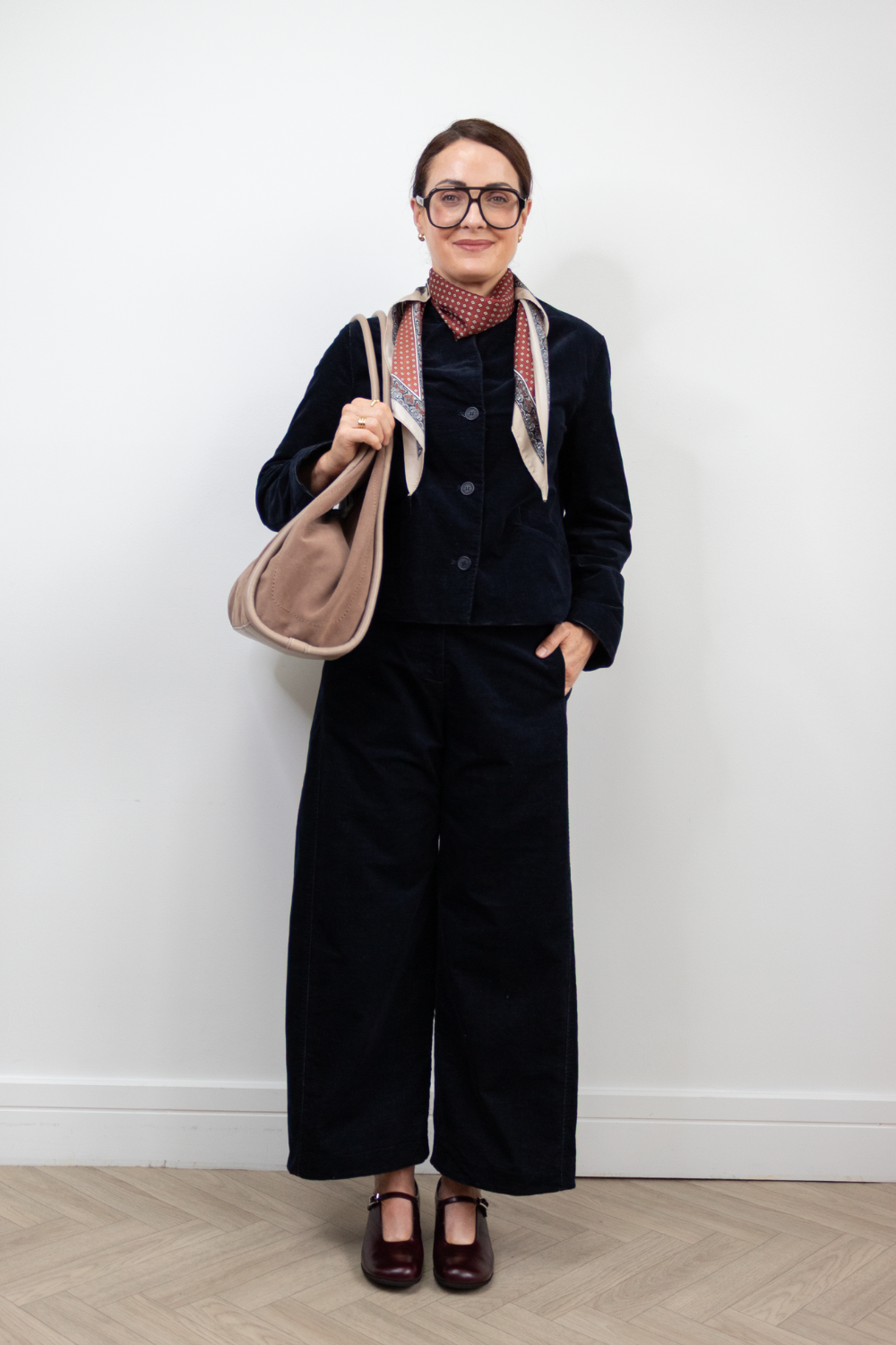 Lifestyle image of woman wearing burgundy Wonders mary-janes with depeche bag