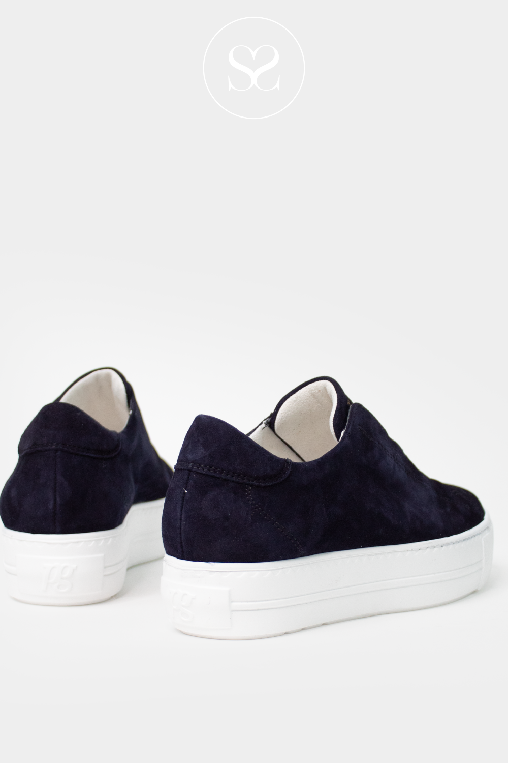 Navy slip-on sneakers with white soles and elasticated laces. Elevated white sole.
