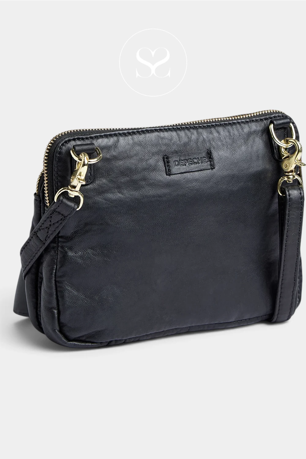 A black faux-leather crossbody clutch bag with gold-tone hardware and a small black brand patch on the front, shown on a light gray background.