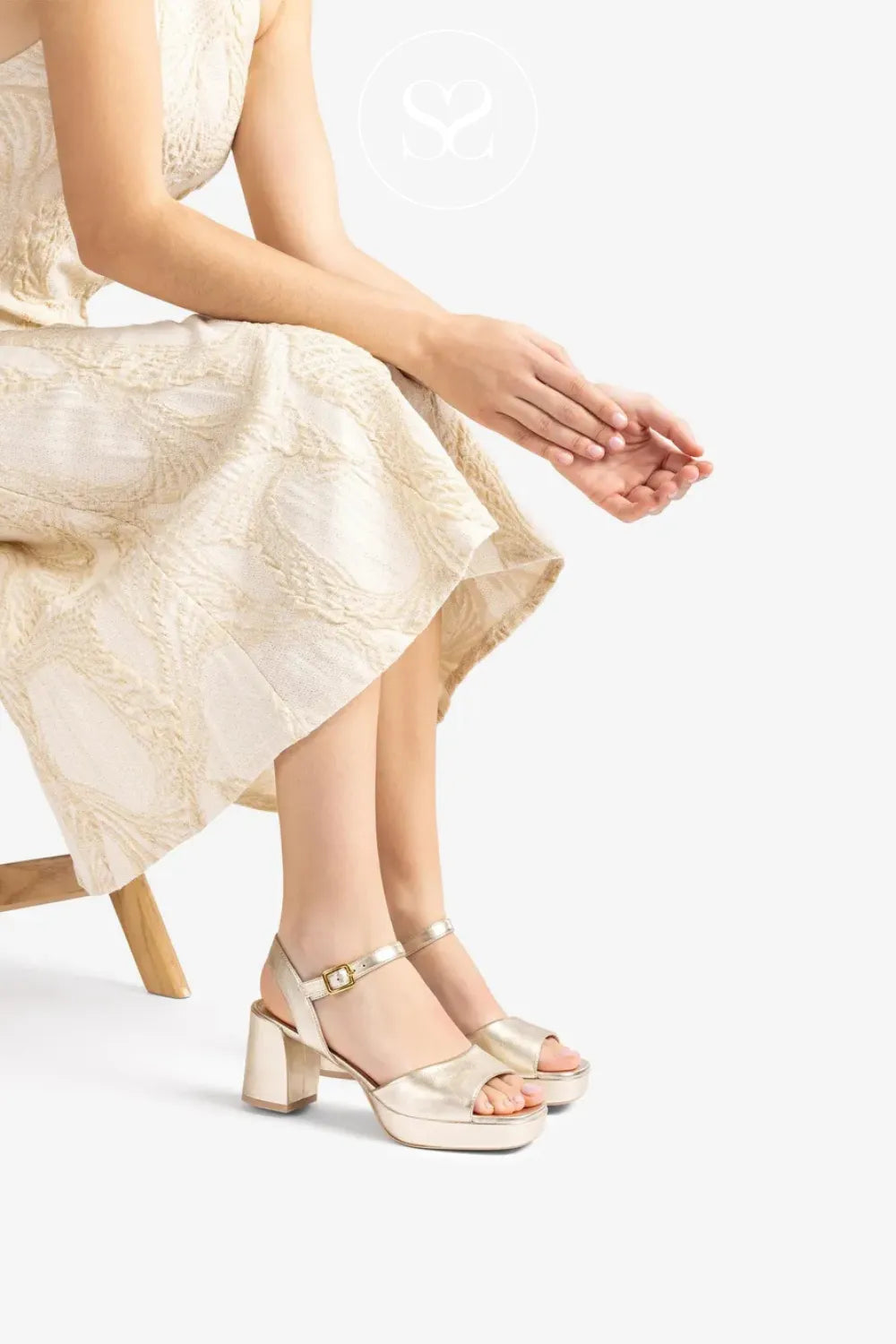 Woman wearing gold comfortable platform sandals wide fit