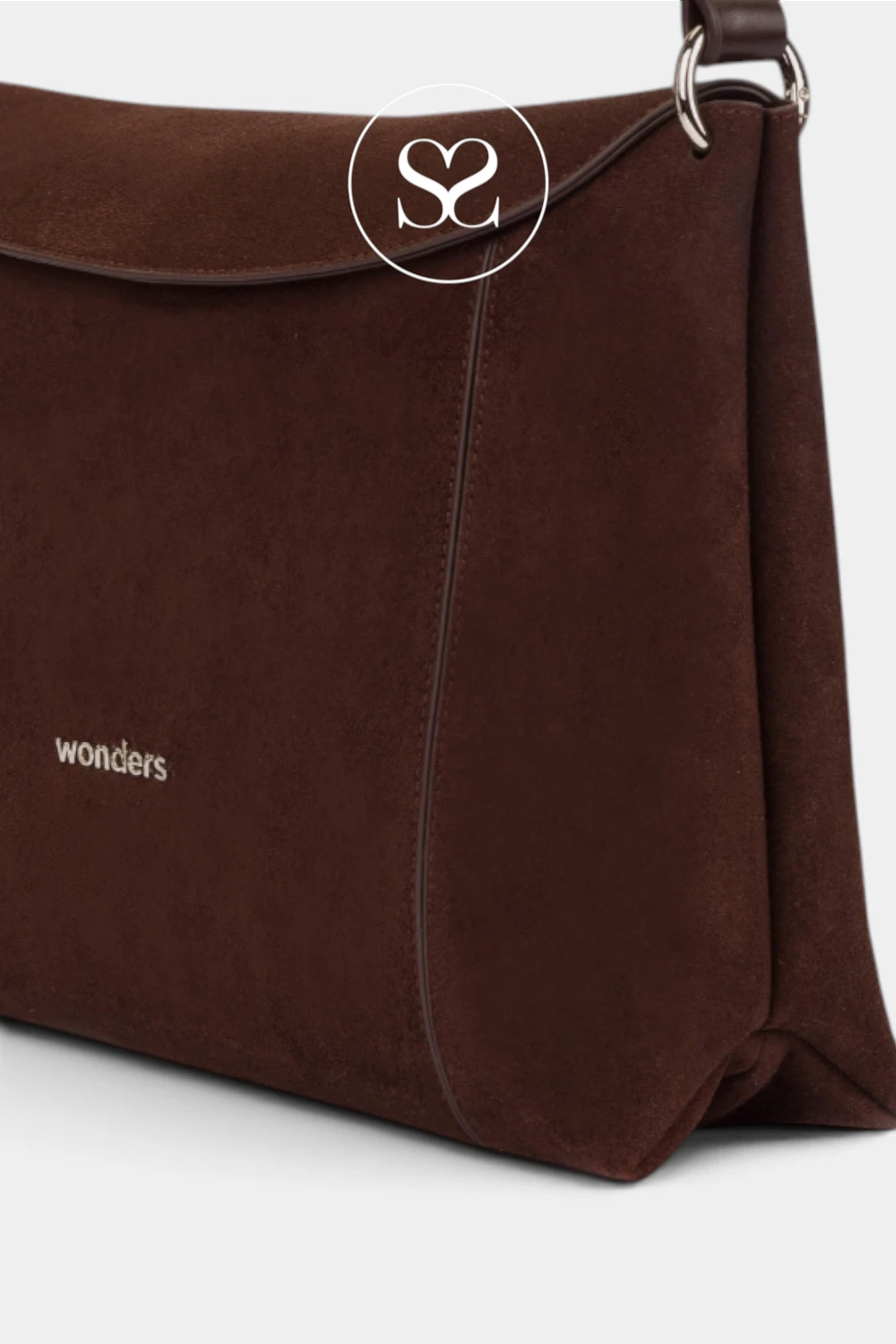 A close-up of a dark brown suede shoulder bag with a flap closure, featuring the brand name 'wonders' in white text on the lower left and a circular 'S2' logo overlay near the top center.