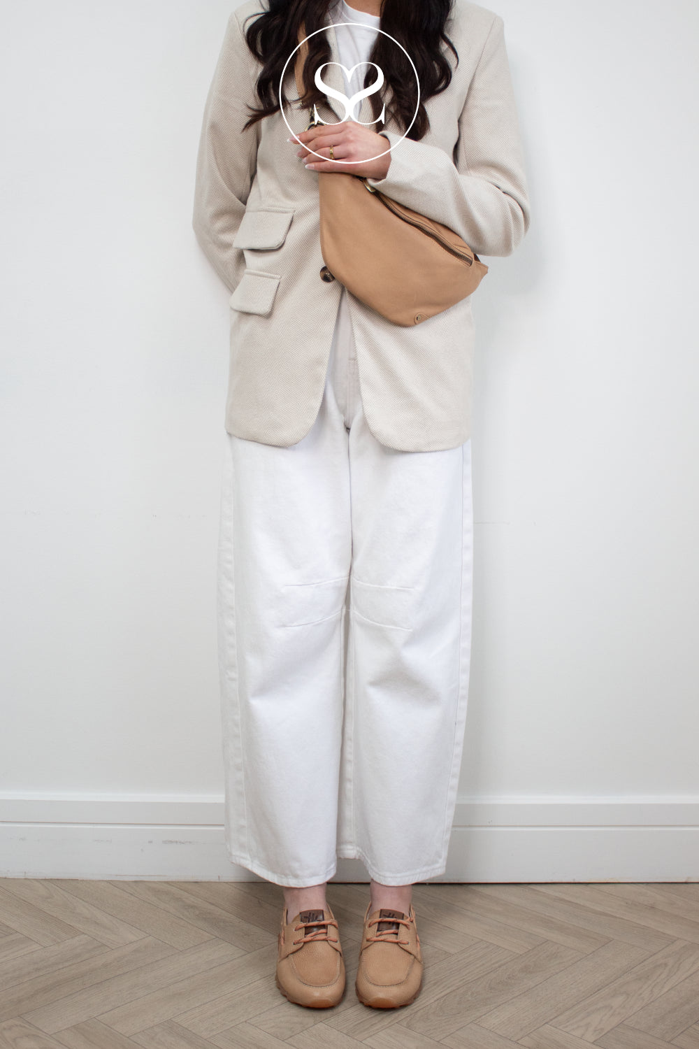 Woman wearing camel hispanitas boat shoes with matching camel crossbody bag from Depeche