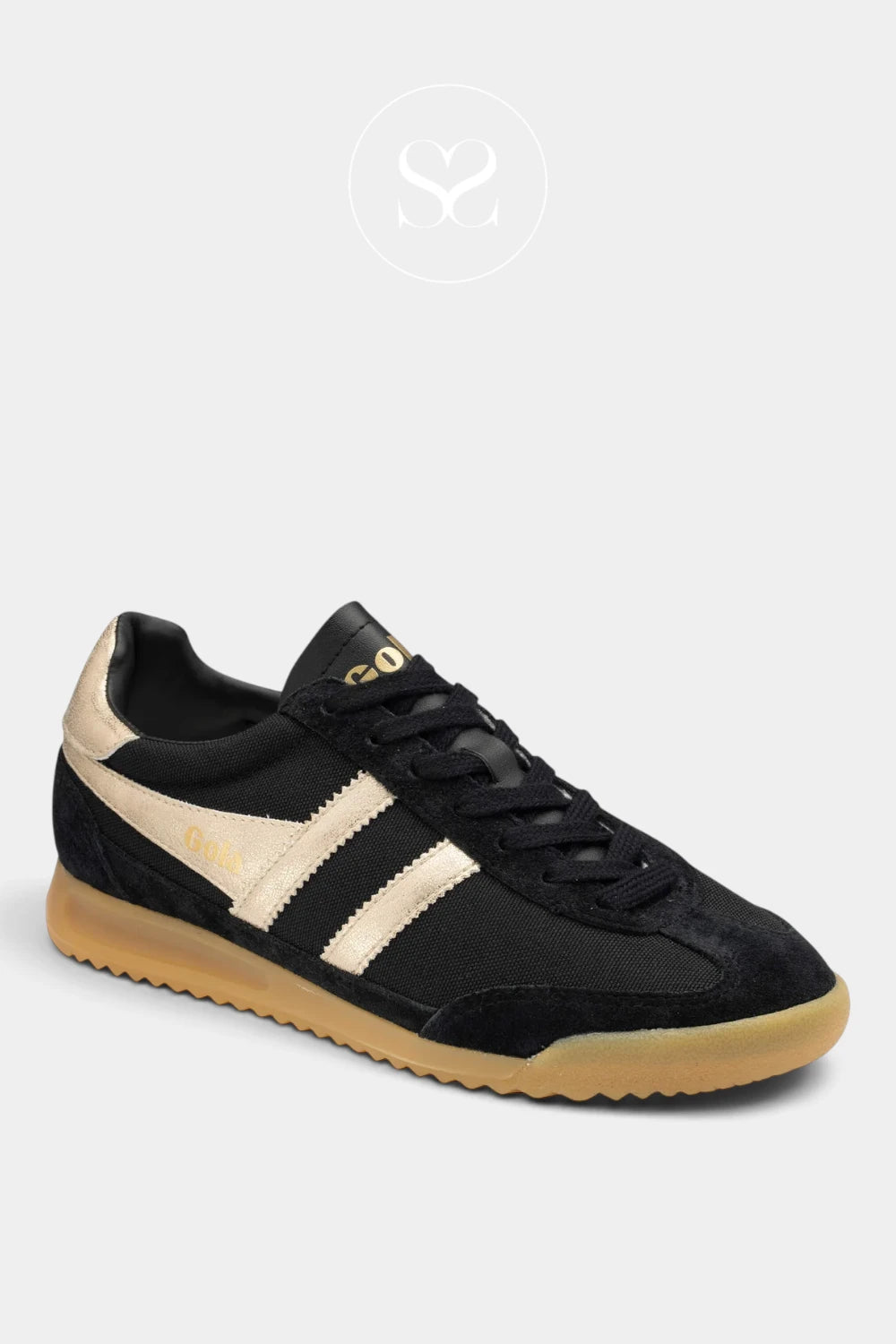 A black suede and canvas low-top sneaker with beige side stripes, a black tongue, and a gum sole, shown on a light gray background.
