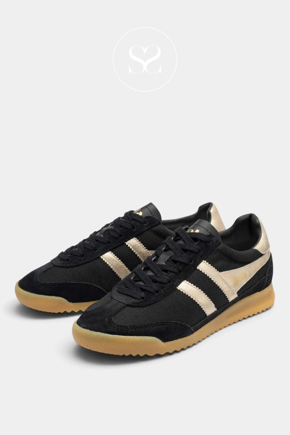 A pair of black low-top sneakers with beige side stripes and a gum sole, displayed on a light gray background with a faint brand logo at the top.