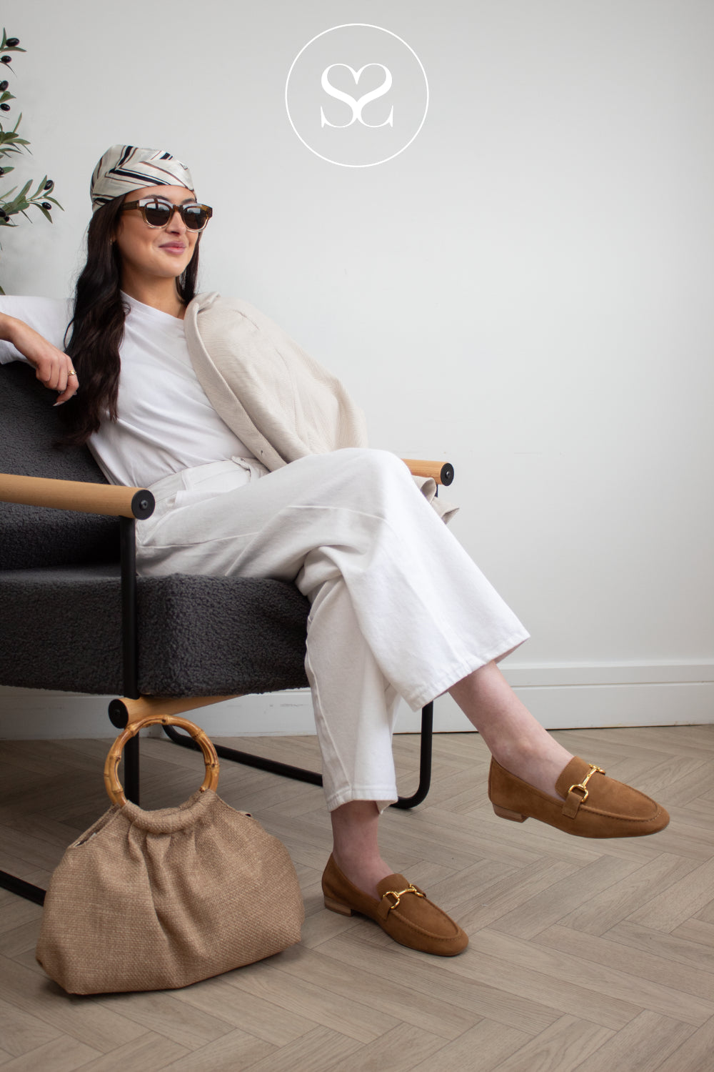 unisa tan suede slip on loafers on woman in ireland styled with white outfit and unisa woven bag