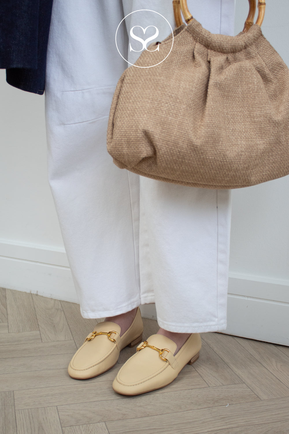 woman wearing butter yellow unisa penny loafers - belgi style along with unisa zemma woven bag