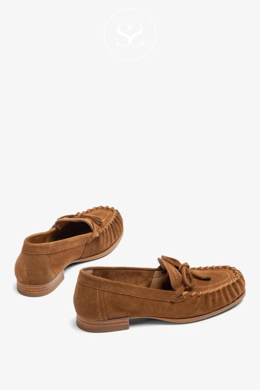 Unisa Dalma tan suede slip on loafer, boat shoe. Round toe with twist and bow feature. Low block heel. Leather insole.