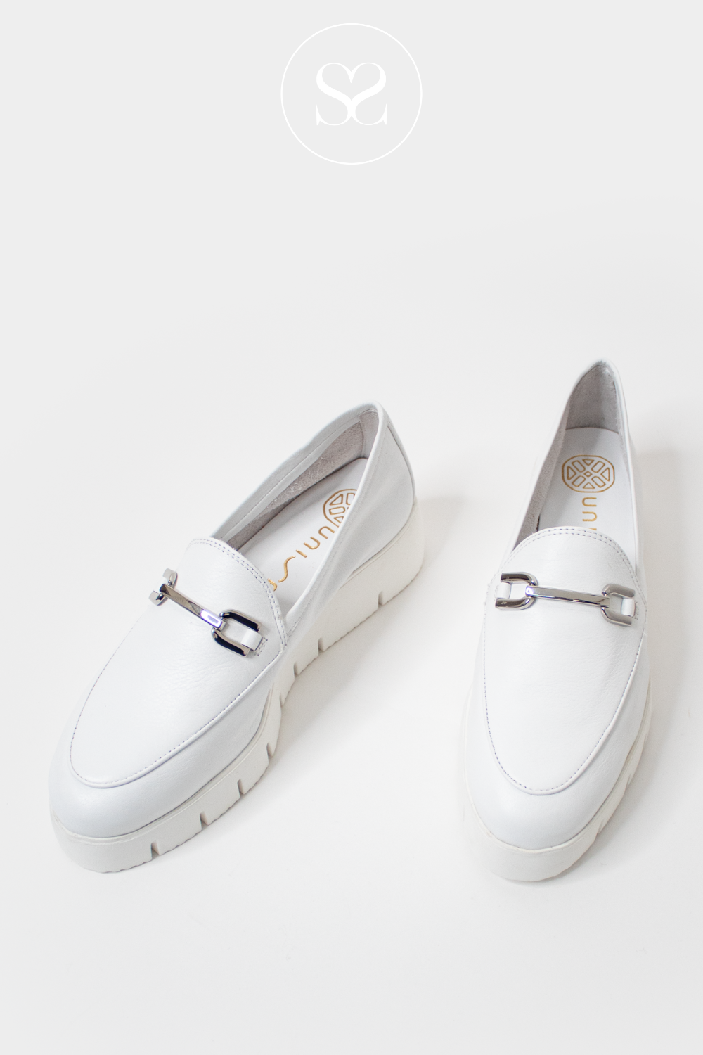 UNISA FAMO WHITE LEATHER SLIP ON WEDGE LOAFERS WITH SILVER BUCKLE