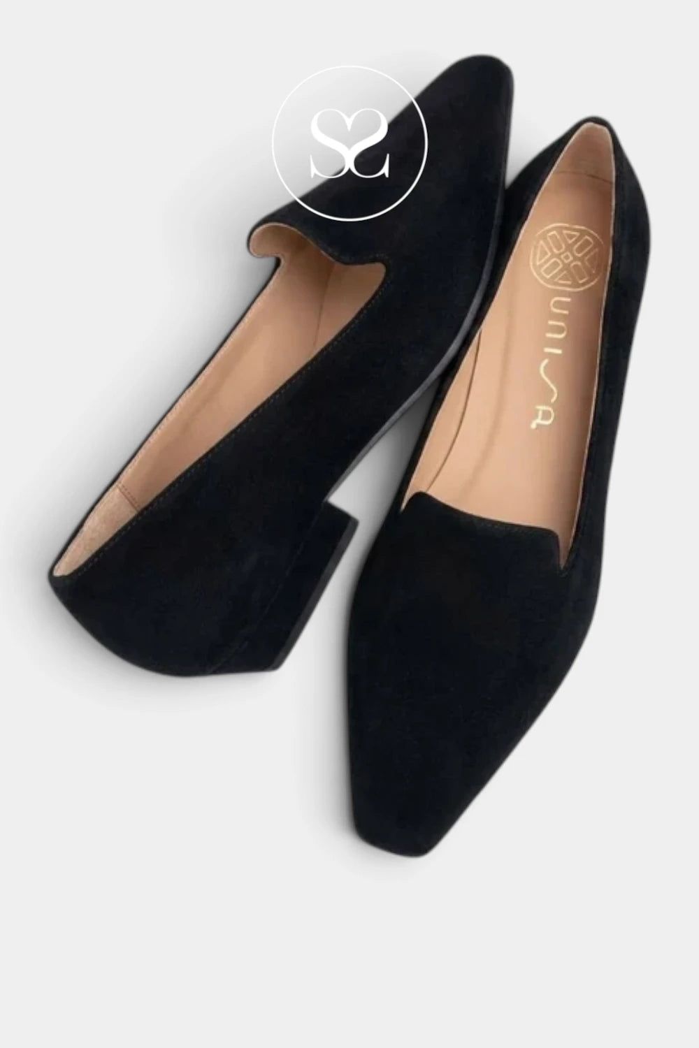 A pair of black suede pointed-toe flats with low block heels, shown from a top-down angle on a light gray background. The brand name 'unisa' is printed on the tan insole of the right shoe, and a circular 'Sheneil Shoes' watermark is visible at the top.