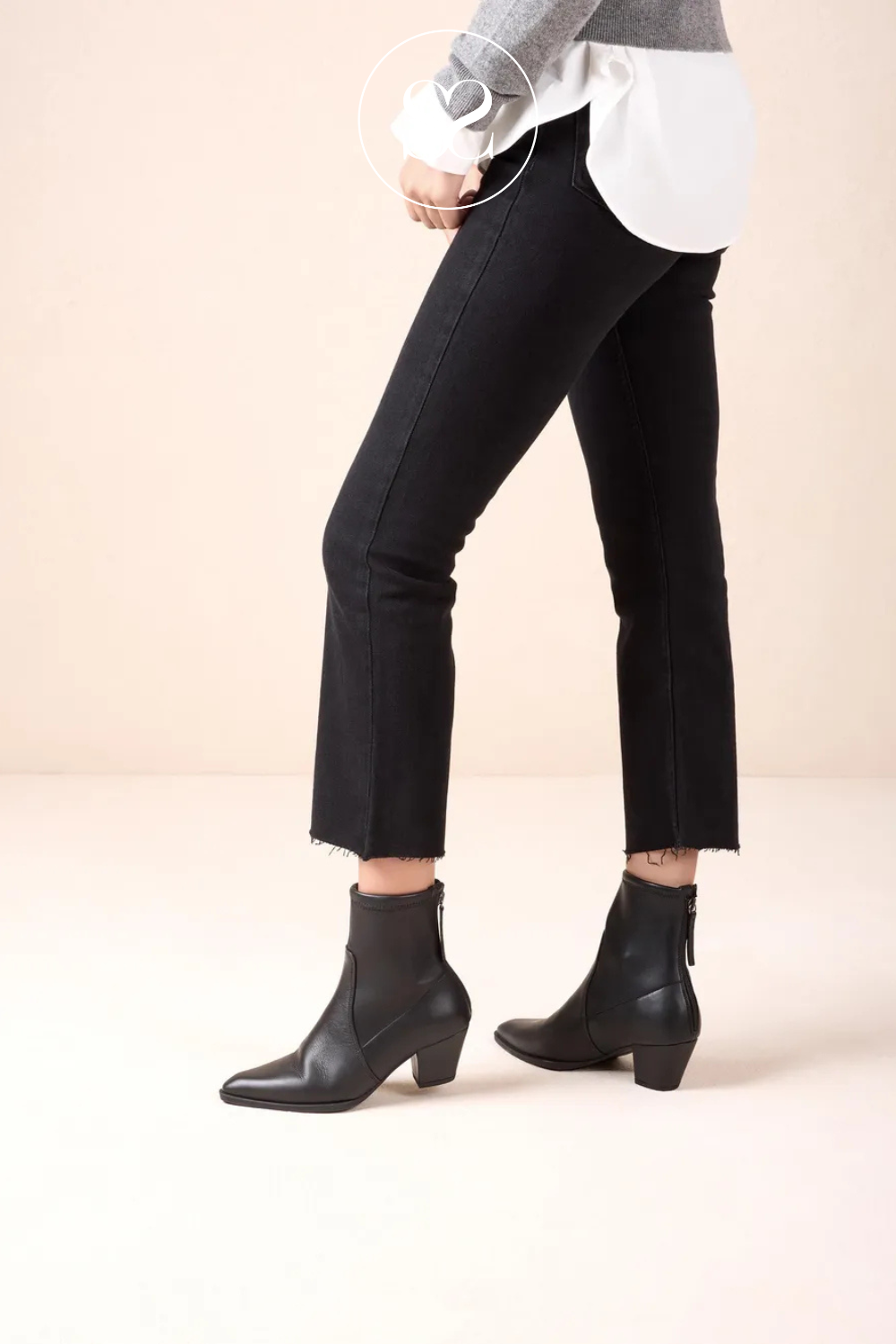 woman wearing black pointed toe western boots from Unisa with sock style calf and rear zip