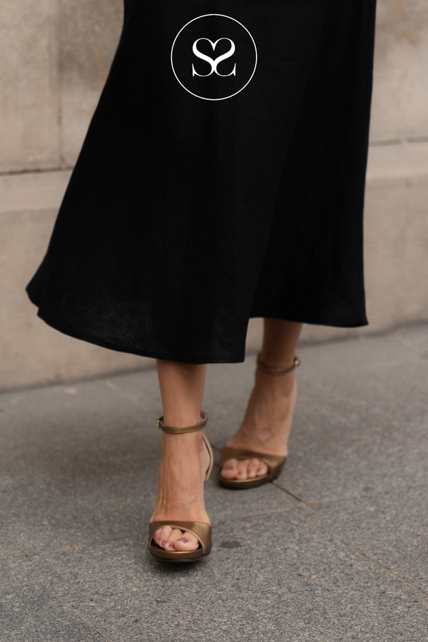 woman wearing Unisa yong bronze sandals