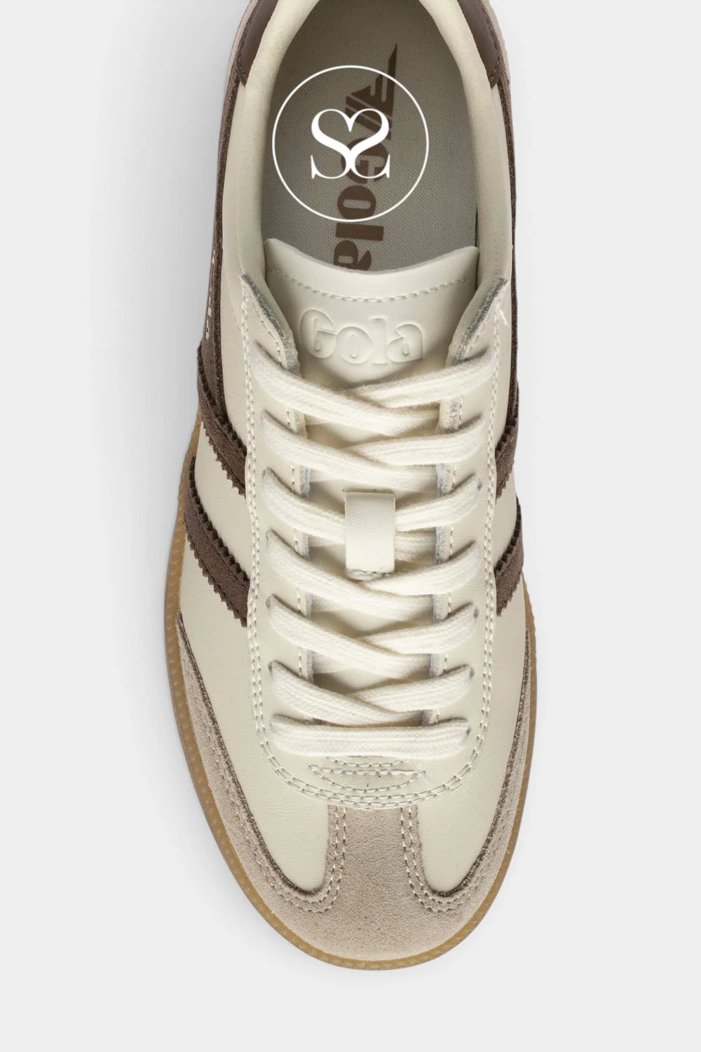 A top-down view of a low-top sneaker in off-white and brown, featuring white laces, a beige suede toe cap, and a brown side stripe pattern. The brand name 'GOA' is embossed on the tongue, and a circular 'S2' logo is visible inside the collar.