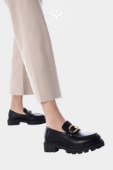Woman wearing chunky black loafers from XTI Ireland