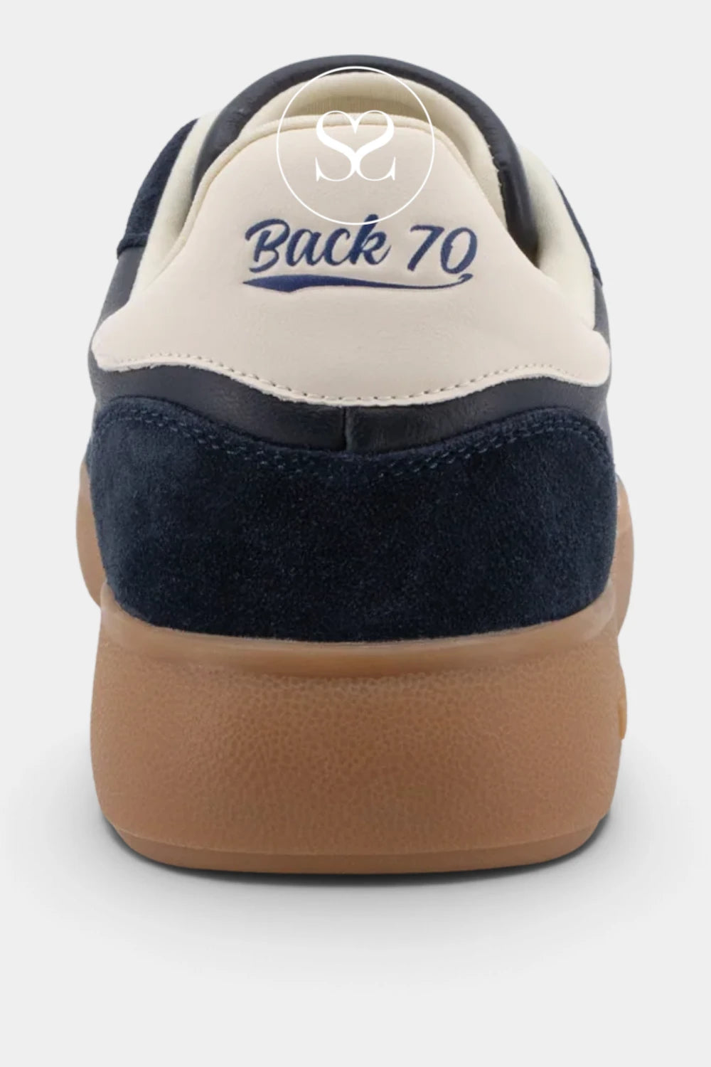 Rear view of a Back 70 sneaker featuring navy blue suede and cream leather panels with a gum brown sole, on a light gray background.
