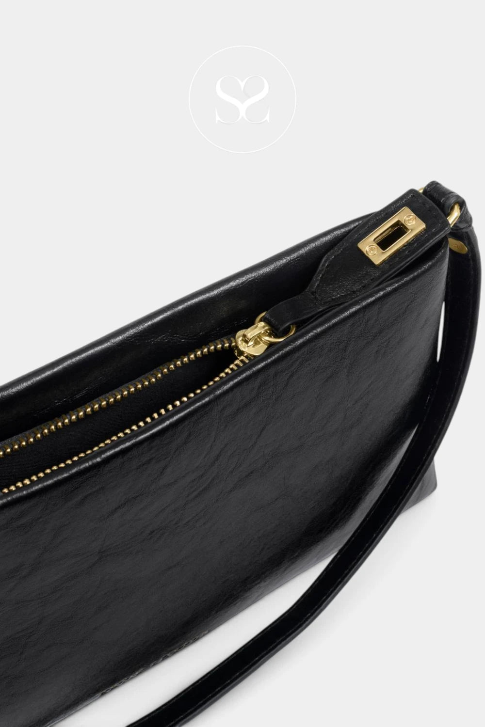 Close-up of a black leather clutch bag with a gold zipper and gold-tone hardware, shown on a light gray background.