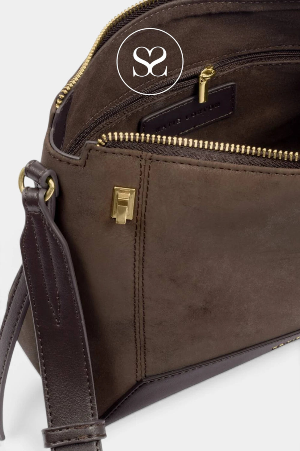 A close-up of a dark brown leather shoulder bag with gold-tone hardware, showing the interior zippered compartments and a matching strap against a light gray background.