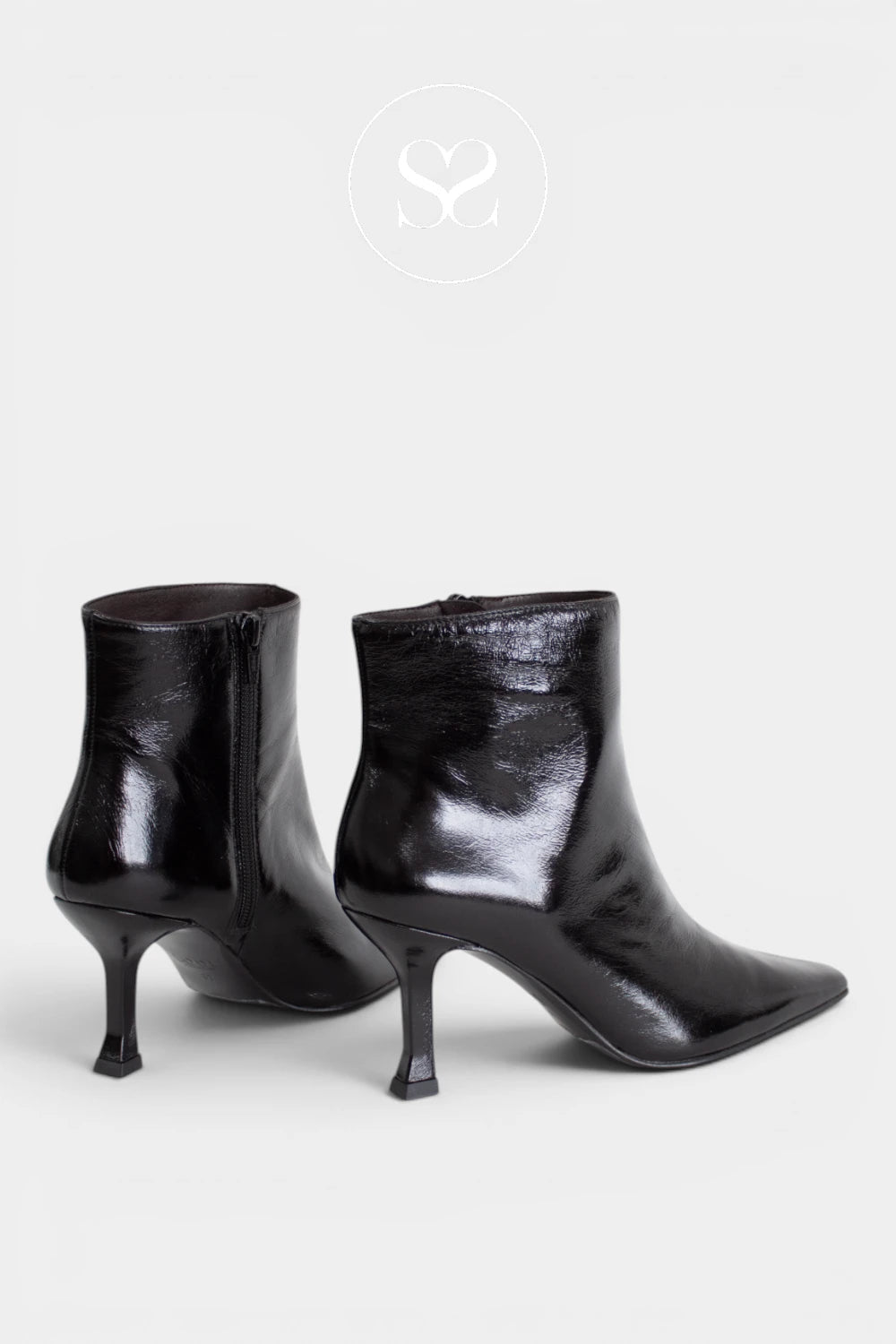 A pair of black pointed-toe ankle boots with kitten heels, shown from the side and back on a light gray background.