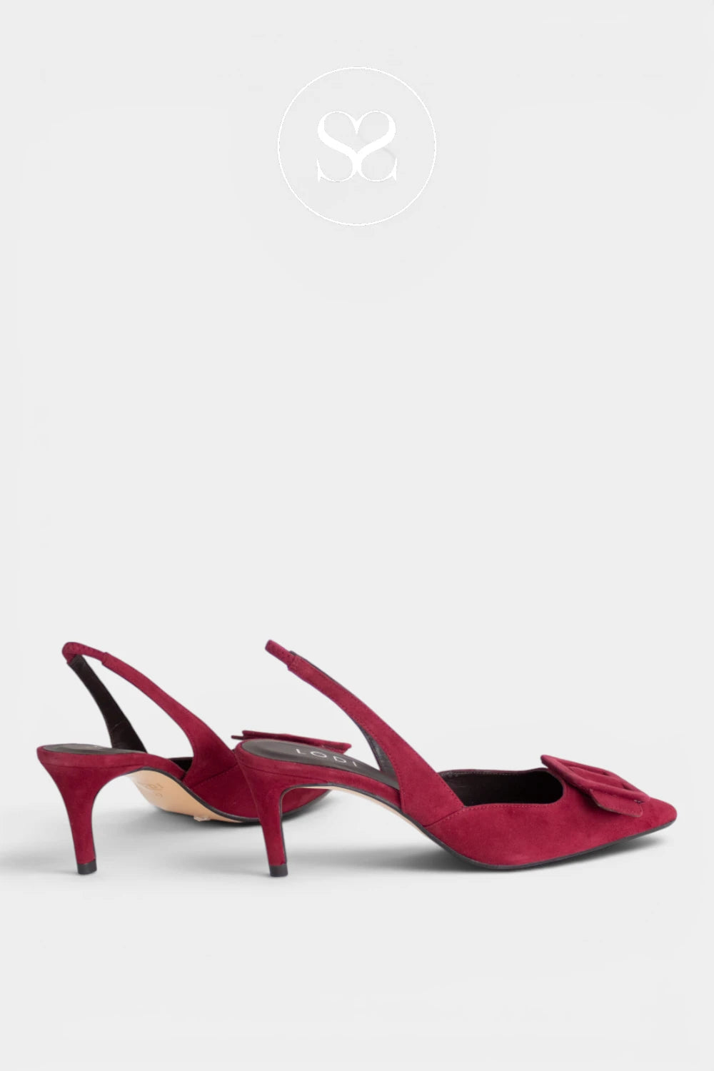 A pair of deep burgundy suede slingback pumps with kitten heels and a bow detail on the toe, shown against a light gray background.