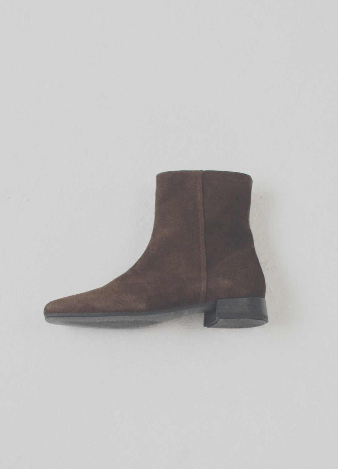 Brown suede ankle boots with a low heel.
