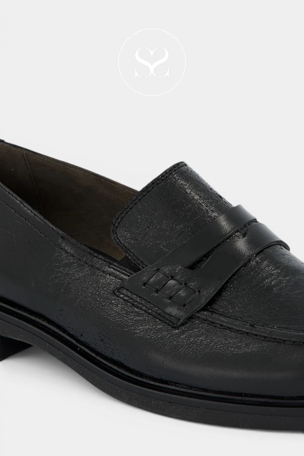 Paul Green Minimal black slip-on shoe finished with understated gold branding at the heel for a premium detail.