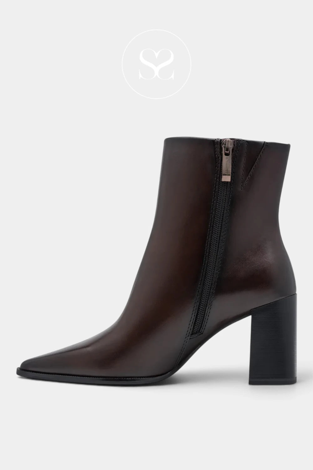A dark brown leather ankle boot with a pointed toe, a chunky block heel, and a side zipper, shown against a light gray background.